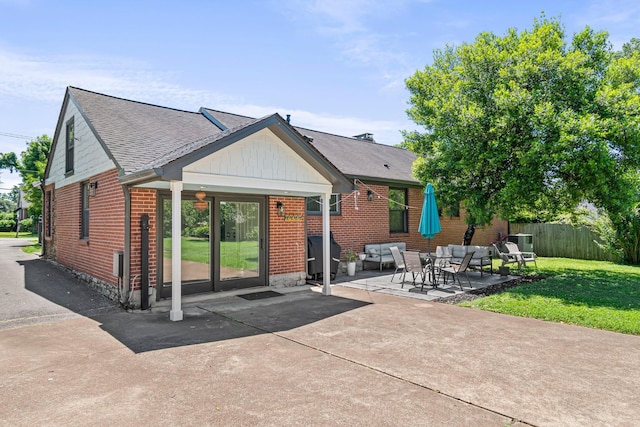 1135 Riverwood Dr, Nashville, TN 37216 - rear view of property with outdoor lounge area, brick siding, a patio area, and a shingled roof