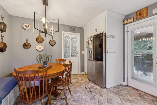 3130 Valley Bend Rd, Murfreesboro, TN 37129 - dining area with brick patterned floors, baseboards, and a chandelier
