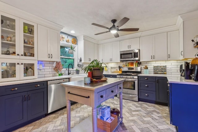 3130 Valley Bend Rd, Murfreesboro, TN 37129 - kitchen featuring appliances with stainless steel finishes, white cabinetry, light countertops, a sink, and brick patterned floors