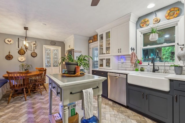 3130 Valley Bend Rd, Murfreesboro, TN 37129 - kitchen featuring stainless steel dishwasher, a sink, white cabinetry, light countertops, and brick floors