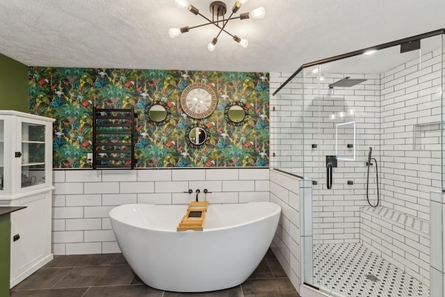 3130 Valley Bend Rd, Murfreesboro, TN 37129 - bathroom featuring wallpapered walls, a chandelier, a soaking tub, a shower stall, and tile walls