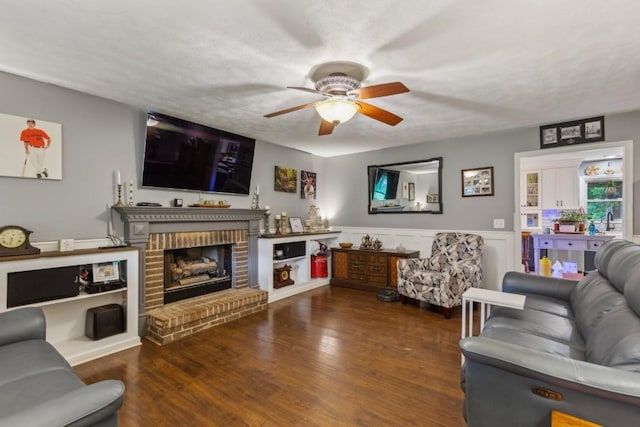 3130 Valley Bend Rd, Murfreesboro, TN 37129 - living area featuring ceiling fan, wood finished floors, a fireplace, and a wainscoted wall
