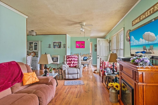 410 Sinking Creek Rd, Petersburg, TN 37144 - living room with ceiling fan, a textured ceiling, crown molding, wood finished floors, and heating unit