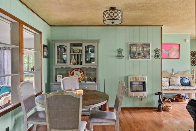 410 Sinking Creek Rd, Petersburg, TN 37144 - dining room with heating unit, crown molding, a textured ceiling, wood finished floors, and baseboards