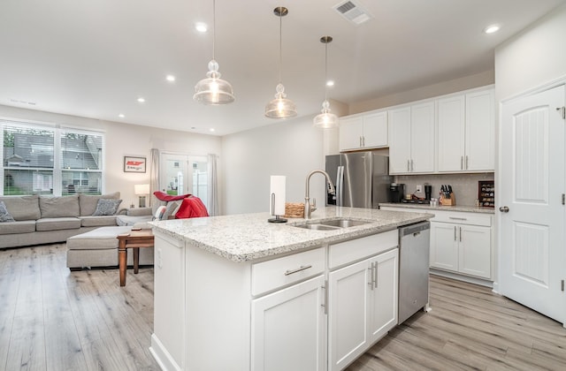 2023 Sperling Dr, Gallatin, TN 37066 - kitchen with a sink, appliances with stainless steel finishes, light wood-style flooring, recessed lighting, and white cabinets