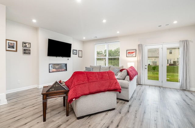 2023 Sperling Dr, Gallatin, TN 37066 - living room featuring light wood-type flooring, recessed lighting, baseboards, and a glass covered fireplace