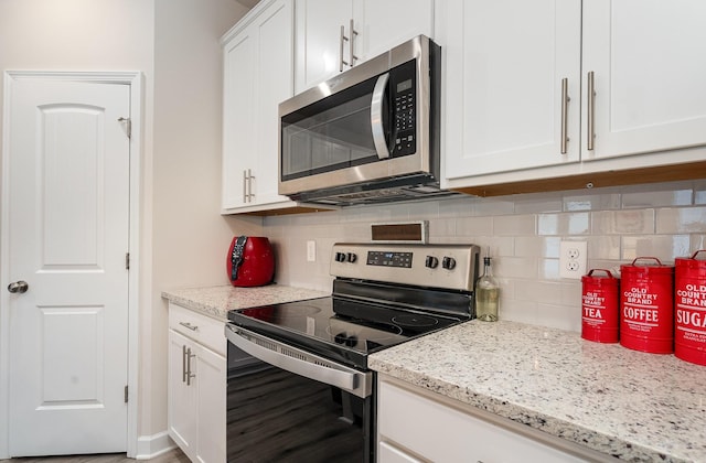 2023 Sperling Dr, Gallatin, TN 37066 - kitchen with appliances with stainless steel finishes, decorative backsplash, white cabinetry, and light stone counters