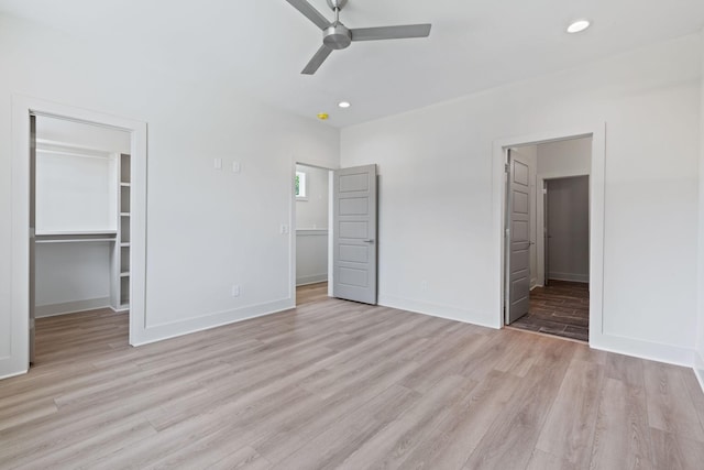 5509 Urbandale Ave, Nashville, TN 37209 - unfurnished bedroom featuring a walk in closet, light wood-style flooring, baseboards, and recessed lighting