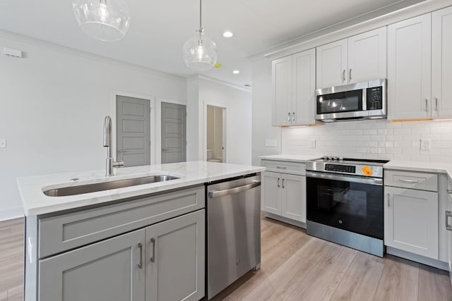 5509 Urbandale Ave, Nashville, TN 37209 - kitchen with stainless steel appliances, a sink, tasteful backsplash, light wood finished floors, and ornamental molding