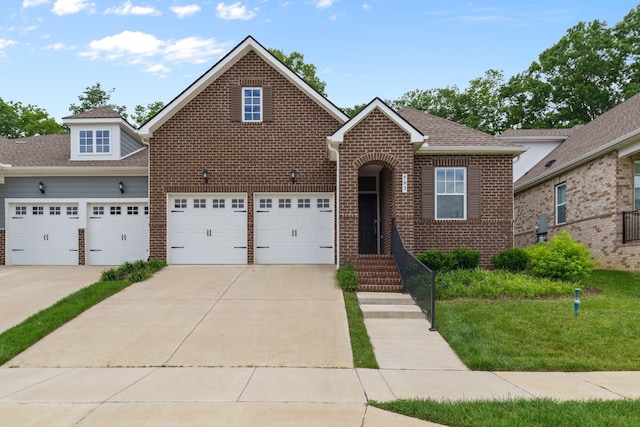 503 Gingerwood Ln, Hendersonville, TN 37075 - traditional-style house with driveway, brick siding, a front yard, and an attached garage