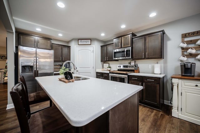 4526 Culpepper Cir, Murfreesboro, TN 37129 - kitchen with stainless steel appliances, a sink, dark brown cabinetry, dark wood-style floors, and light countertops