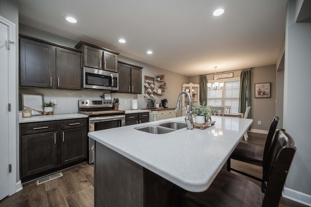 4526 Culpepper Cir, Murfreesboro, TN 37129 - kitchen with appliances with stainless steel finishes, a sink, a kitchen island with sink, light countertops, and a chandelier