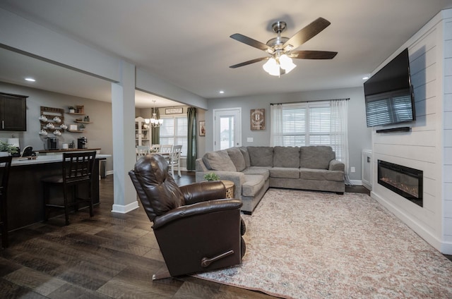 4526 Culpepper Cir, Murfreesboro, TN 37129 - living area featuring a chandelier, a fireplace, a ceiling fan, dark wood-type flooring, and baseboards