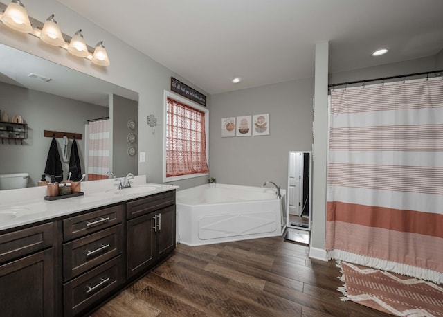 4526 Culpepper Cir, Murfreesboro, TN 37129 - full bathroom featuring wood finished floors, double vanity, a garden tub, recessed lighting, and toilet