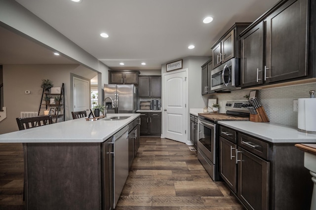 4526 Culpepper Cir, Murfreesboro, TN 37129 - kitchen with stainless steel appliances, dark brown cabinetry, dark wood-style flooring, light countertops, and recessed lighting