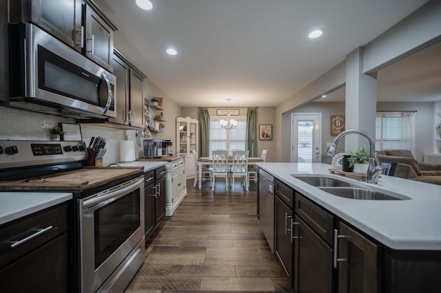 4526 Culpepper Cir, Murfreesboro, TN 37129 - kitchen featuring appliances with stainless steel finishes, a sink, light countertops, dark wood-style floors, and recessed lighting