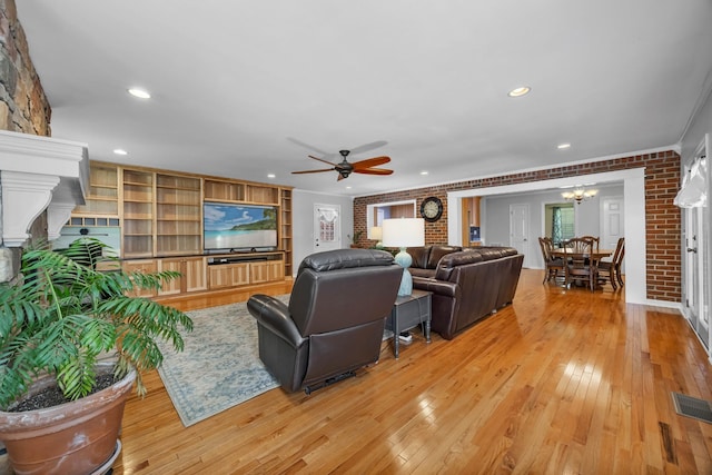 346 Lynnford Dr, Murfreesboro, TN 37128 - living room with light wood-style flooring, a ceiling fan, a chandelier, brick wall, and recessed lighting