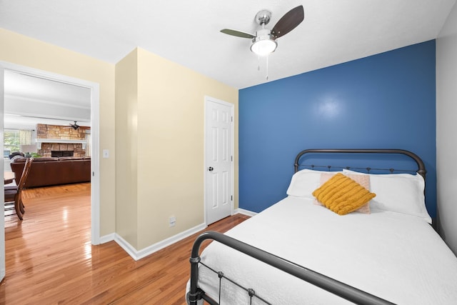 346 Lynnford Dr, Murfreesboro, TN 37128 - bedroom featuring wood finished floors, a stone fireplace, baseboards, and ceiling fan