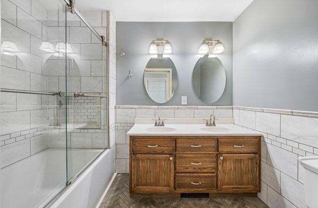 346 Lynnford Dr, Murfreesboro, TN 37128 - bathroom with tile walls, shower / bath combination with glass door, double vanity, and wainscoting