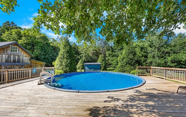 346 Lynnford Dr, Murfreesboro, TN 37128 - swimming pool with a wooden deck, view of wooded area, and an outdoor structure