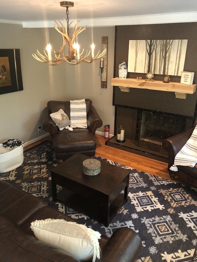 470 Askin Ln, Baxter, TN 38544 - living room featuring a chandelier, wood finished floors, crown molding, baseboards, and a fireplace