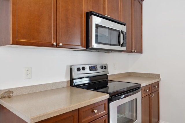 3511 Blaze Dr, Murfreesboro, TN 37128 - kitchen with appliances with stainless steel finishes, light countertops, and brown cabinets