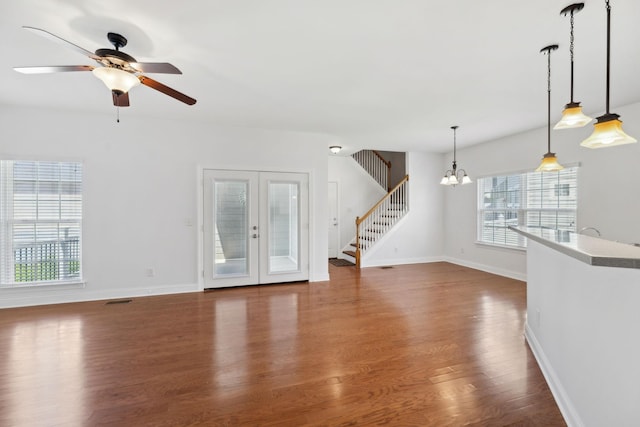 3511 Blaze Dr, Murfreesboro, TN 37128 - unfurnished living room featuring dark wood-type flooring, stairs, a ceiling fan, a chandelier, and baseboards