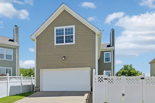 3511 Blaze Dr, Murfreesboro, TN 37128 - view of home's exterior featuring an attached garage, driveway, and a chimney
