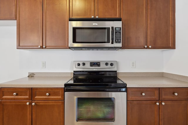 3511 Blaze Dr, Murfreesboro, TN 37128 - kitchen featuring stainless steel appliances, light countertops, and brown cabinetry
