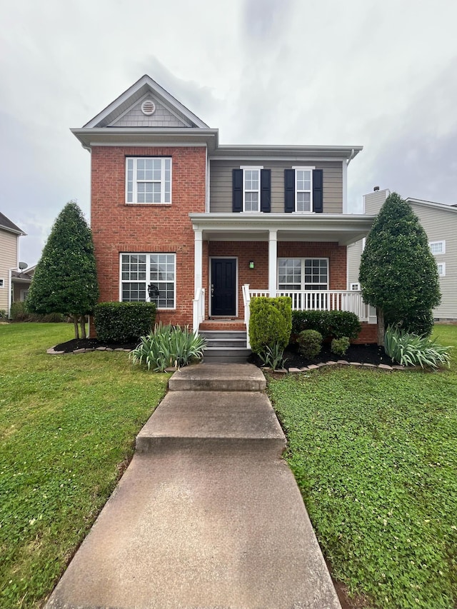 3511 Blaze Dr, Murfreesboro, TN 37128 - view of front of house featuring brick siding, a front yard, and covered porch
