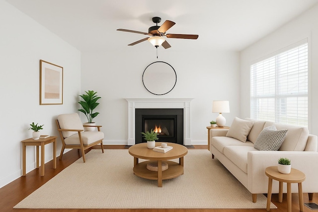 3511 Blaze Dr, Murfreesboro, TN 37128 - living room featuring wood finished floors, a fireplace with flush hearth, ceiling fan, and baseboards
