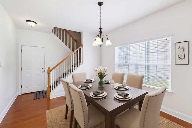 3511 Blaze Dr, Murfreesboro, TN 37128 - dining area with a chandelier, wood finished floors, stairs, and baseboards