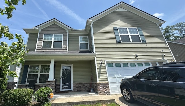 1225 Silverstream Pt, Antioch, TN 37013 - view of front of home with a porch, an attached garage, and stone siding