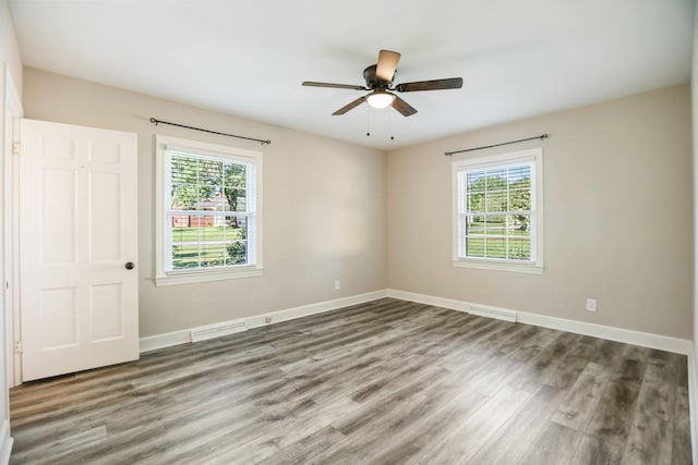 1625 Shady Cir, Lebanon, TN 37087 - unfurnished bedroom featuring wood finished floors, multiple windows, baseboards, and a ceiling fan