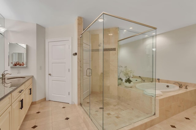110 31st Ave N Unit 301, Nashville, TN 37203 - bathroom featuring tile patterned floors, a garden tub, double vanity, a stall shower, and recessed lighting