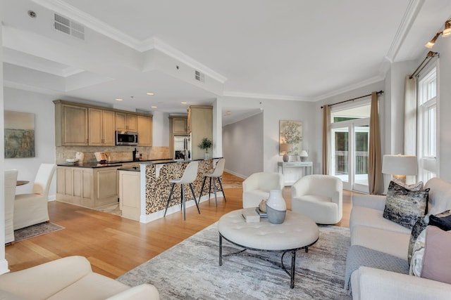 110 31st Ave N Unit 301, Nashville, TN 37203 - living area featuring light wood-style flooring, crown molding, and baseboards