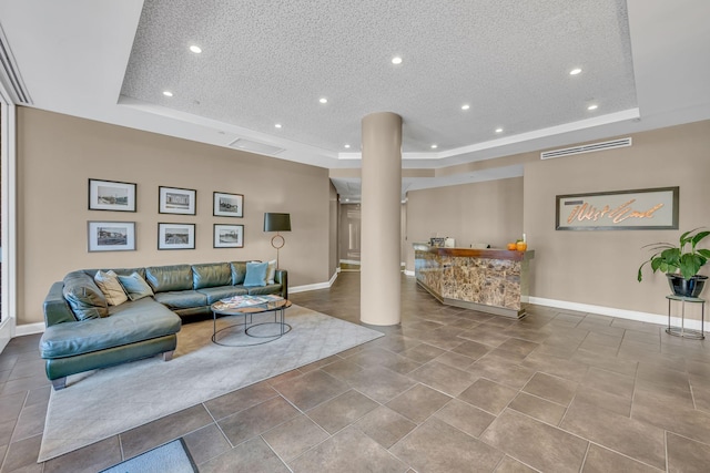 110 31st Ave N Unit 301, Nashville, TN 37203 - living area featuring a tray ceiling, recessed lighting, baseboards, decorative columns, and a textured ceiling