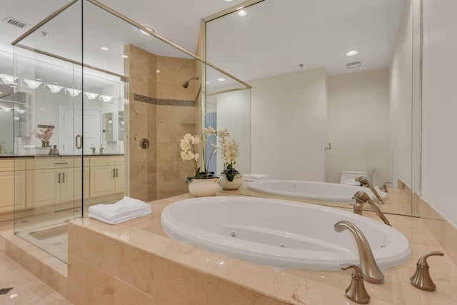 110 31st Ave N Unit 301, Nashville, TN 37203 - full bath featuring vanity, a tub with jets, tiled shower, and recessed lighting