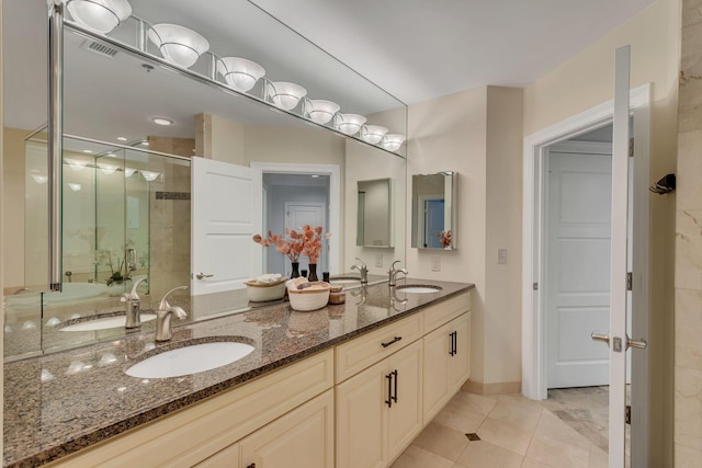 110 31st Ave N Unit 301, Nashville, TN 37203 - bathroom featuring double vanity, a shower stall, and tile patterned flooring