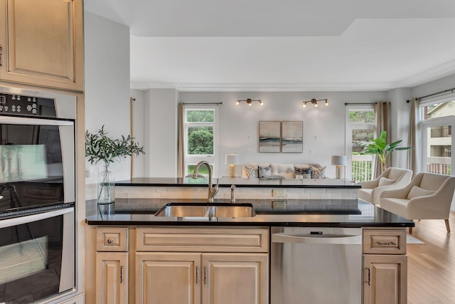 110 31st Ave N Unit 301, Nashville, TN 37203 - kitchen with stainless steel appliances, a sink, open floor plan, and dark countertops