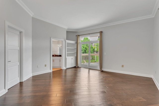 110 31st Ave N Unit 301, Nashville, TN 37203 - spare room featuring crown molding, dark wood-style floors, and baseboards