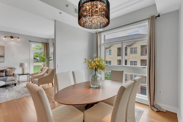 110 31st Ave N Unit 301, Nashville, TN 37203 - dining space featuring light wood-style flooring, baseboards, and a chandelier