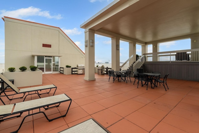 110 31st Ave N Unit 301, Nashville, TN 37203 - view of patio with outdoor dining area, a grill, and stairs