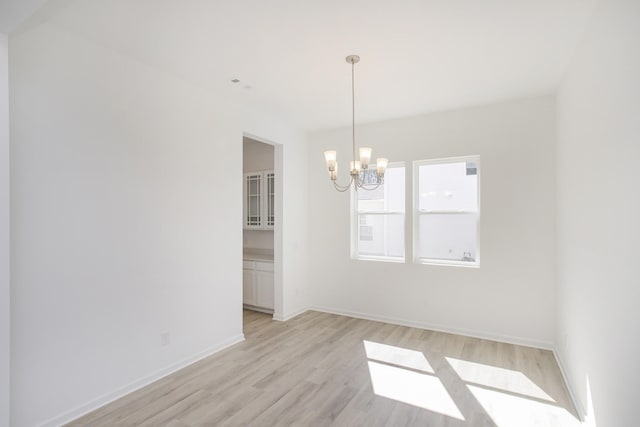 3044 Fernwood Ln, Columbia, TN 38401 - unfurnished dining area with a chandelier, light wood-style flooring, and baseboards