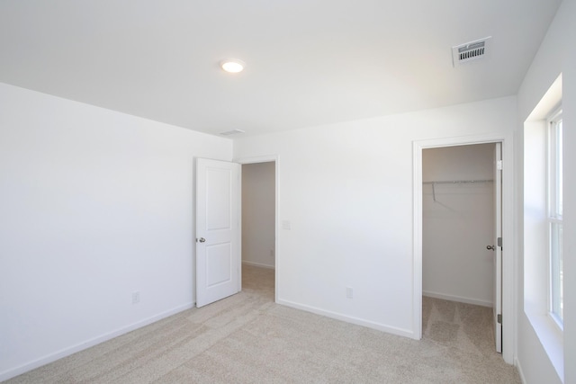 3044 Fernwood Ln, Columbia, TN 38401 - unfurnished bedroom featuring light carpet, a spacious closet, a closet, and baseboards