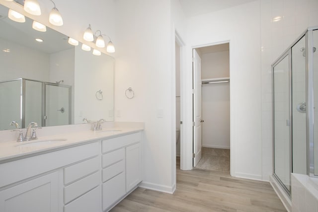 3044 Fernwood Ln, Columbia, TN 38401 - bathroom with a shower stall, double vanity, wood finished floors, baseboards, and toilet