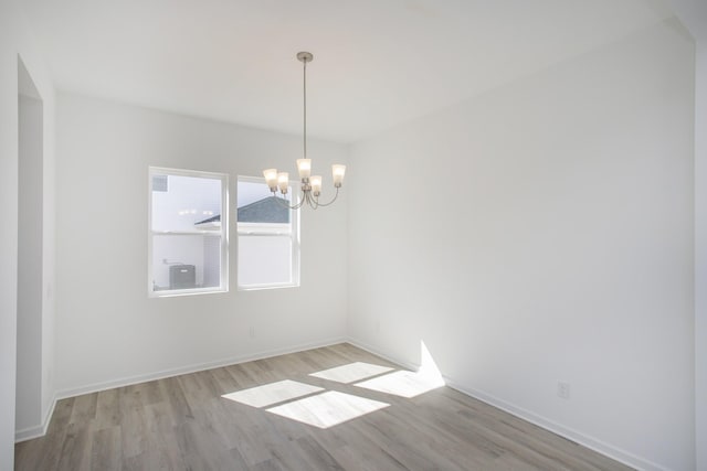 3044 Fernwood Ln, Columbia, TN 38401 - empty room featuring light wood-style floors, a chandelier, and baseboards
