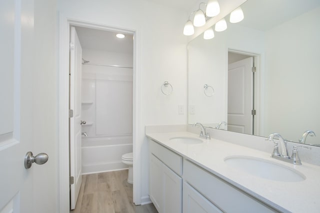 3044 Fernwood Ln, Columbia, TN 38401 - bathroom featuring double vanity, wood finished floors, toilet, and bathtub / shower combination