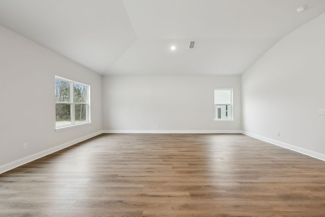 126 Cades Blf, Lebanon, TN 37087 - empty room featuring lofted ceiling, healthy amount of natural light, wood finished floors, baseboards, and recessed lighting