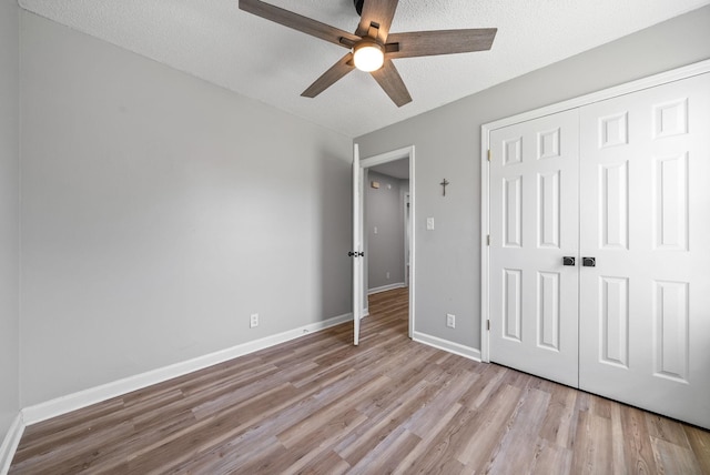 337 Atlantic Ave, Oak Grove, KY 42262 - unfurnished bedroom with wood finished floors, a closet, baseboards, a ceiling fan, and a textured ceiling